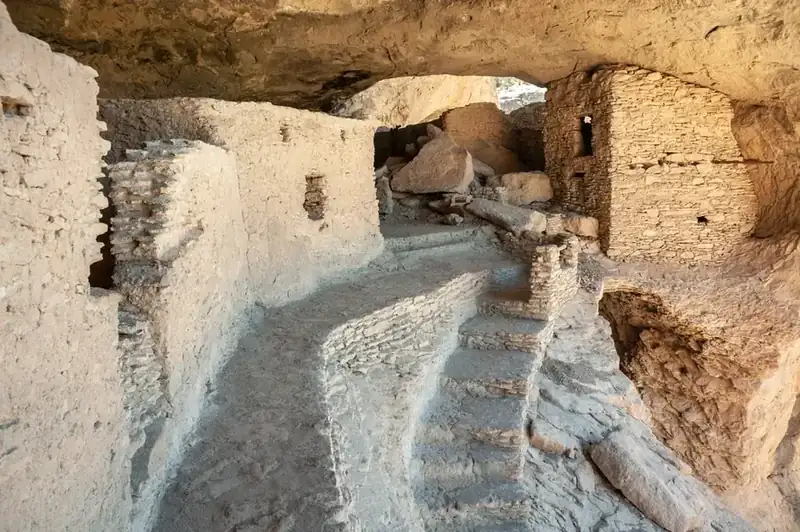Rooms and stairways inside a cliff dwelling under a stone overhang